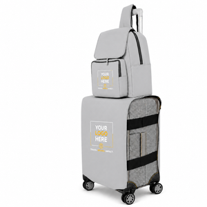 A light gray luggage set including a rolling suitcase, a matching backpack, and a carry-on bag, all featuring a customizable 'YOUR LOGO HERE' patch on the front. The suitcase has a heathered gray exterior with black mesh side panels and black wheels.